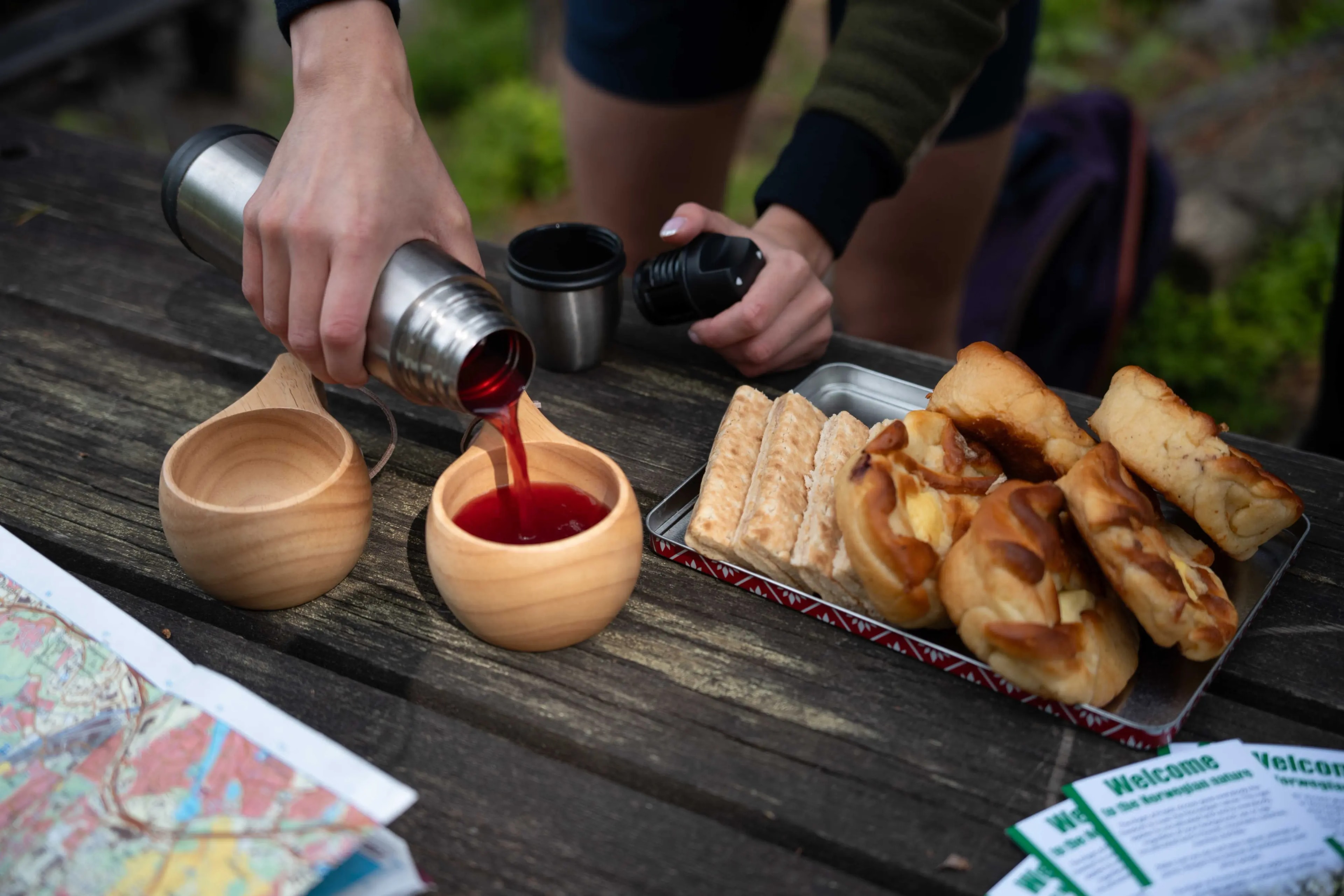 Warm drink and cinnamon bun at a cozy cabin